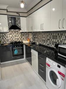 a kitchen with a washing machine and a washer at Modern Comfort In Atasehir in Istanbul