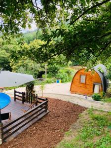 a small wooden cabin with a table and benches at Gallas Pod House in Vouzela