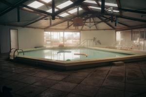 a large pool in a building with at Hotel Palma de Mallorca in La Paloma