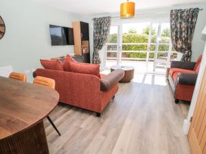 a living room with two couches and a table at Rose Lodge in Alnwick