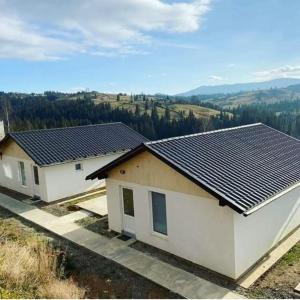 a house with solar panels on top of it at Котеджі Зоряне Небо in Bukovel