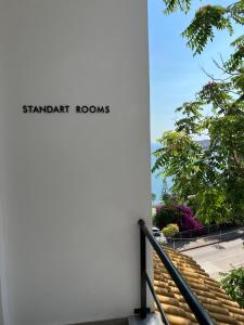 a sign on the side of a building with stairs at Kanes Boutique Hotel in Sarandë