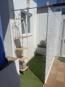 a patio with a ladder and a chair on the grass at Garden-Goretti House in Mairena del Aljarafe