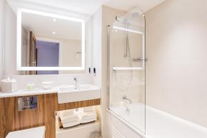 a bathroom with a sink and a shower at Courtyard by Marriott Glasgow Airport in Paisley