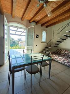 a dining room with a glass table and chairs at Residenza Casa Bianca in Marina di Massa