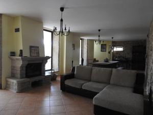 a living room with a couch and a fireplace at Casa da Aldeia MGS in Laundos