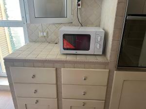 a microwave oven sitting on a counter in a kitchen at Mare fuori in Bari