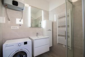 a bathroom with a washing machine and a sink at Eni apartments BOL in Bol