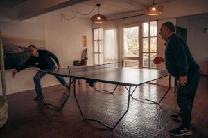 two men playing ping pong on a ping pong table at Hotel Palma de Mallorca in La Paloma