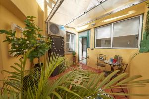 a room with a table and some plants in it at Lx Factory Apartment! Outside terrace in Lisbon