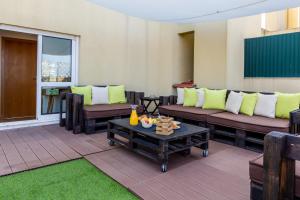 a patio with couches and a coffee table at One Bedroom Apartment with Stunning River Views and Private Rooftop! in Lisbon
