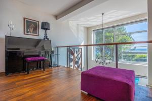 a living room with a piano and a purple couch at Villa CD in Dramalj