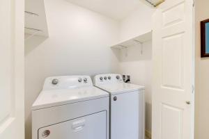 a white laundry room with a washer and dryer at Waterfront Kenai Townhome Less Than 1 Mi to Beach! in Kenai