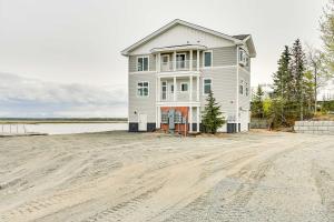 a house on the beach with a dirt road at Waterfront Kenai Townhome Less Than 1 Mi to Beach! in Kenai