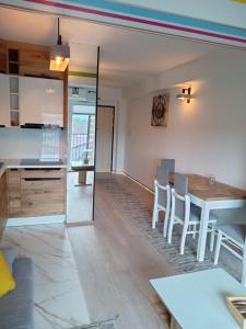 a kitchen and dining room with a table and chairs at Apartament Sądecki in Nowy Sącz