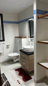 a bathroom with a toilet and a sink at Maya Plage, Villa en bord de mer in Cap Skirring