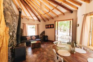 a living room with a table and a couch at Cabañas El Palomar in San Alfonso