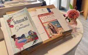 a table topped with books on top of a table at Hotel Alfieri in Sirmione