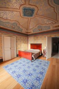 a bedroom with a bed and a blue rug at Case Ruggieri Luxury apt - Don Pietro in Gratteri