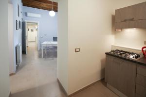a kitchen with a counter and a stove top oven at Case Ruggieri Luxury apt - Don Pietro in Gratteri