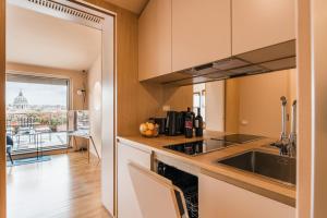 a kitchen with a sink and a view of the city at The Best Rent - Spacious apartment with terraces with panoramic view of Rome in Rome
