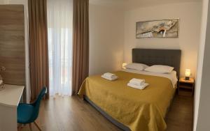 a bedroom with a bed with two towels on it at Apartment Renata in Zadar