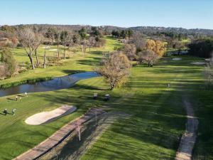 an overhead view of a golf course with a pond at City Nest: Heart of Linksfield in Johannesburg