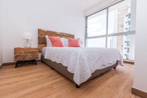 a bedroom with a bed and a large window at Impressive City View Apartment Marbella - PH Quartier Marbella in Panama City