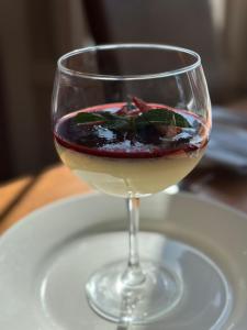 a glass of wine sitting on a plate at Garth Hotel in Grantown on Spey