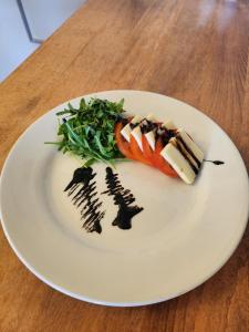 a white plate with food on a wooden table at Garth Hotel in Grantown on Spey