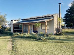 a small house with a grass yard in front of it at La Pasiva in Villa Giardino