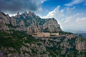 a mountain with a town on top of it at Babu Home Bcn in Santa Coloma de Cervelló