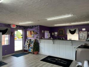 a room with purple walls and a counter in a store at Surry Inn - Dobson in Dobson