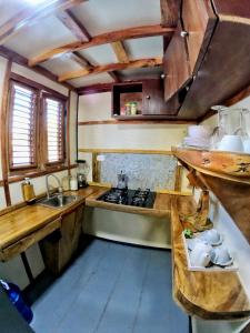 a kitchen with a sink and a stove top oven at Rustic House Punta Rucia in Punta Rucia