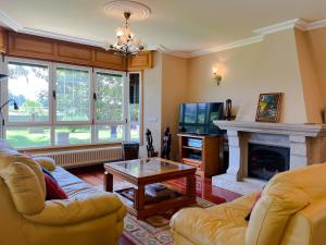 a living room with two couches and a fireplace at Villa Remoan in Vilagarcia de Arousa