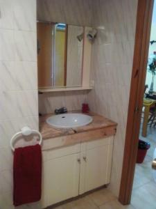 a bathroom with a sink and a mirror at Apartamento 1ª línea de playa!!! in Cambrils