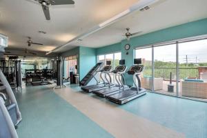 a gym with cardio equipment and a large window at Stars In The Moon Fully Furnished in Houston