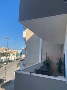 a balcony with a table and plants on a building at ViesteRooms in Vieste +54 photos