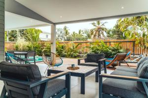 an outdoor patio with chairs and a table at Villa Ilyana - bord de mer- piscine chauffée in La Saline les Bains