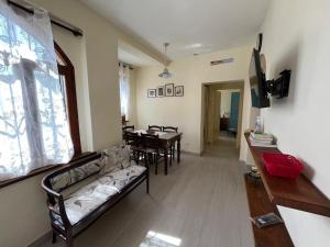 a living room with a couch and a table with chairs at Costa del sole 42 in Cetona