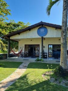 a building with a hammock in front of it at Yabás Praia in Ubatuba