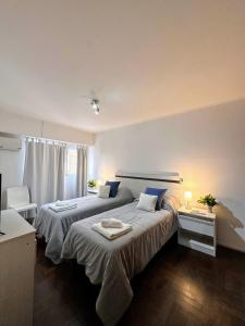 um quarto de hotel com duas camas e uma mesa em El mejor Dpto en Nva Cordoba al alcance de todo!! em Córdoba