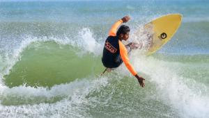 a man riding a wave on a surfboard in the ocean at Surf'n Lanka - Surf School in Weligama