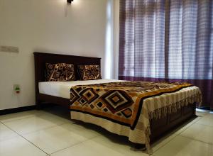 a bedroom with a bed and a window with curtains at Surf'n Lanka - Surf School in Weligama
