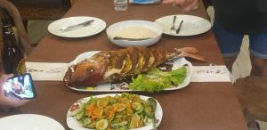 a table with a meal of fish and salad at Surf'n Lanka - Surf School in Weligama