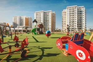 a playground in a city with toys on the grass at Caesar resort & SPA, Claudius 2 bedroom apartment, Iskele, Long beach in Saint Yeorgios