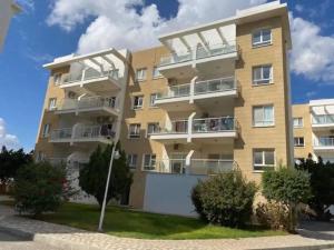 a large apartment building with balconies on it at Caesar resort & SPA, Claudius 2 bedroom apartment, Iskele, Long beach in Saint Yeorgios