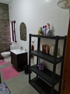 a black shelf in a bathroom with a sink at 4 Bedroom House at Saint julians in St. Julianʼs