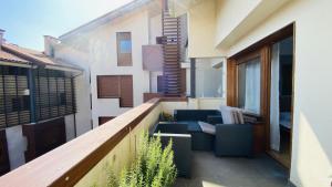 a balcony of a building with furniture on it at Apartamento Playa de Barro in Barro de Llanes