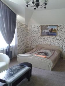 a bedroom with two beds and a table and a window at Guesthouse Agat in Bataysk
